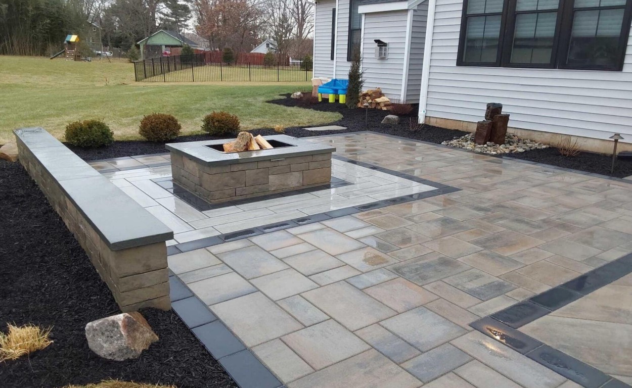 Stamped concrete patio with elegant stone pattern and fire pit